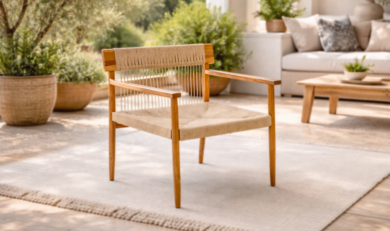Two striped outdoor lounge chairs in blue and terracotta under a matching patio umbrella, set against a stone wall terrace with plants and soft natural light